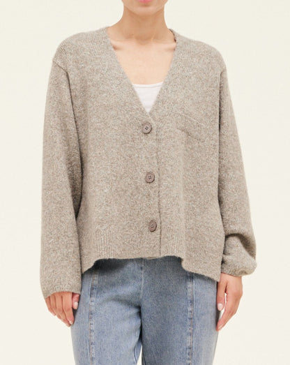 Stay warm and look stylish all season in the Relaxed Knit Cardigan. It's perfectly cozy and features classic details like a pocket and buttons down the front. Its slightly oversized fit is comfortable and flattering, making it a great addition to your wardrobe.