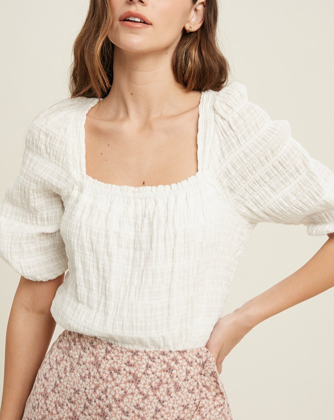 This textured top is an effortless way to add stylish flair to any look. The puff sleeves and square neckline bring a sophisticated feminine charm, while the ivory hue makes it easy to pair with nearly any color bottom.