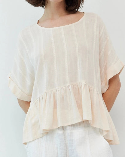 The Woven Ruffle Top is a look that will look fabulous with your entire wardrobe. It features a sweet peplum detail and a breezy material, a staple for that summer to fall transition. 